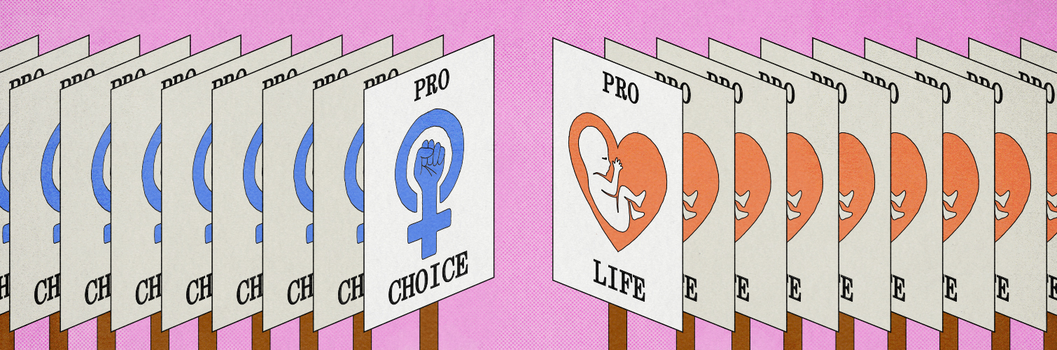 On the left of the image, numerous signs with the text "Pro Choice" and a blue female symbol with fist are opposed against numerous signs with "Pro Life" and a fetus in a red heart symbol on the right of the image.